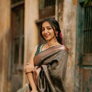 Impressive Dark Green Soft Silk Saree With Gossamer Blouse Piece