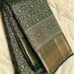 Eloquence Dark Green Soft Banarasi Silk Saree With Engrossing Blouse Piece