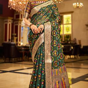 Sumptuous Dark Green Organza Silk Saree With Vestigial Blouse Piece