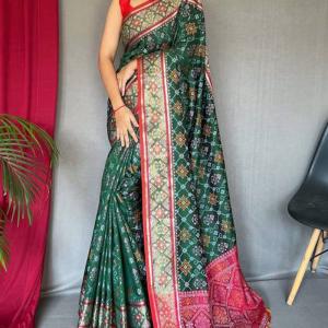 Jazzy Dark Green Patola Silk Saree with Cynosure Blouse Piece
