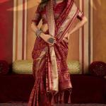 Staring Maroon Patola Silk Saree with Precious Blouse Piece