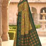 Engaging Green Patola Silk Saree with Smart Blouse Piece