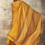 Gratifying Mustard Ajrakh Printed Satin Silk Saree With Enthralling Blouse Piece